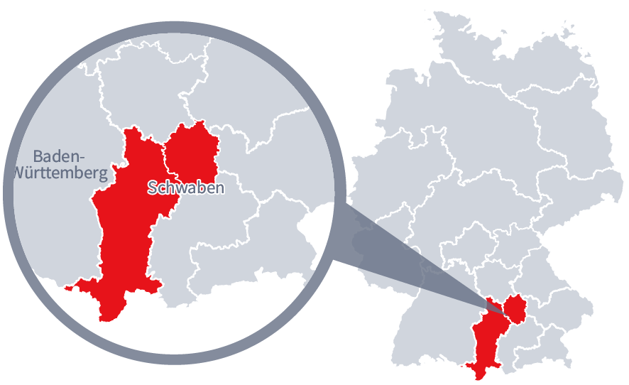 Diese Grafik zeigt eine Karte von Deutschland mit einer detaillierten Ansicht der Region Schwaben. Schwaben ist in Rot hervorgehoben und liegt im südlichen Teil Deutschlands. Ein Lupensymbol vergrößert diesen Bereich, um die Lage genauer darzustellen. 